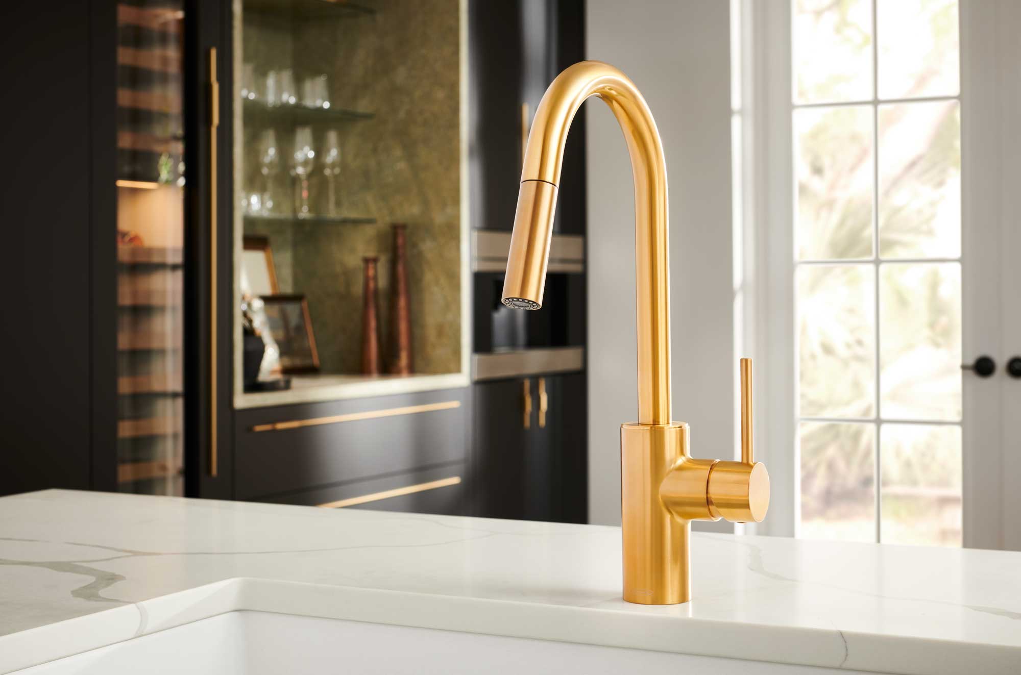A modern kitchen faucet with a sleek design and a luxurious gold finish, enhancing the kitchen's aesthetic appeal.