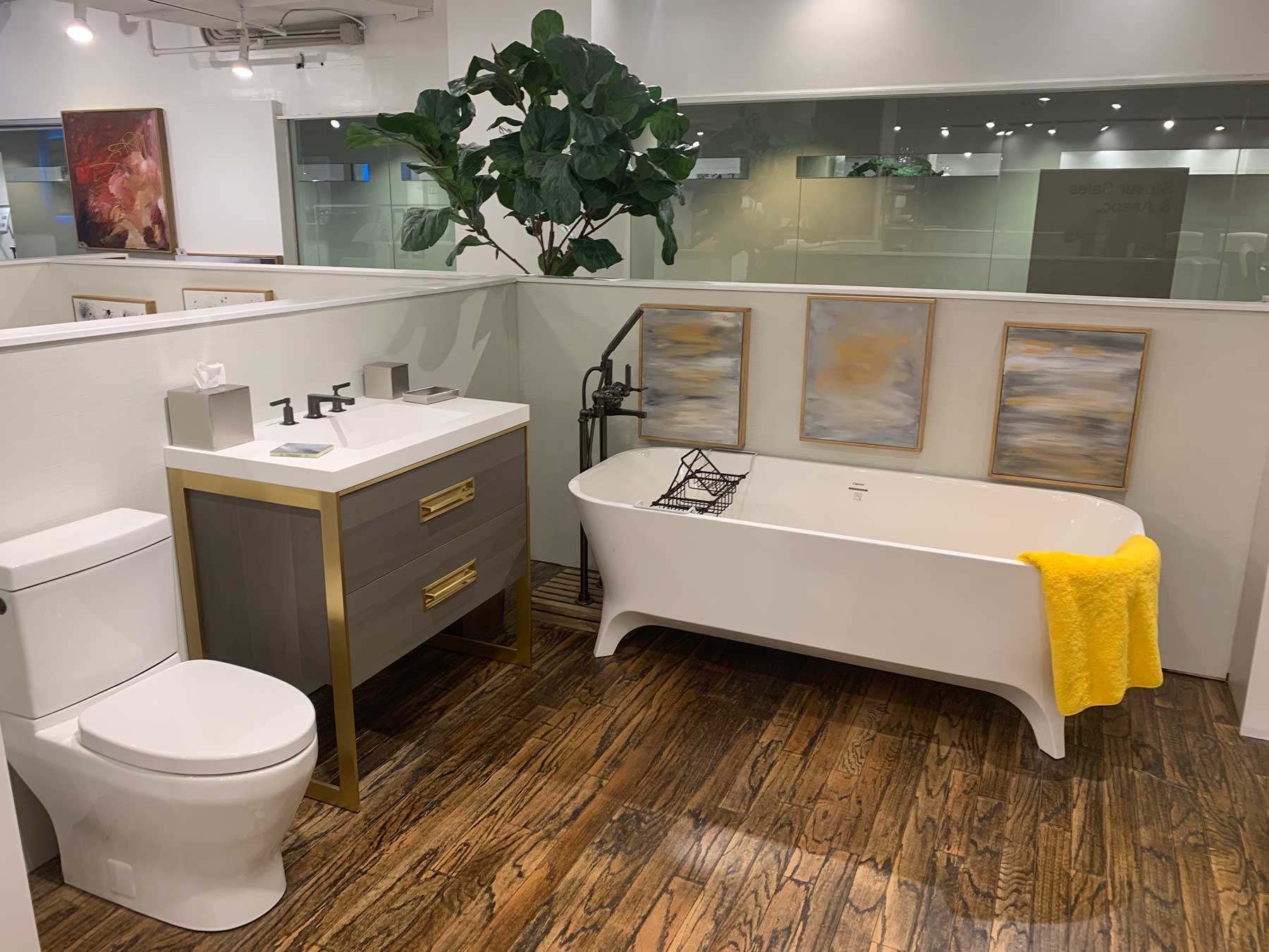 A bathroom featuring a bathtub, toilet, and sink, with neutral-colored walls and tiled flooring.
