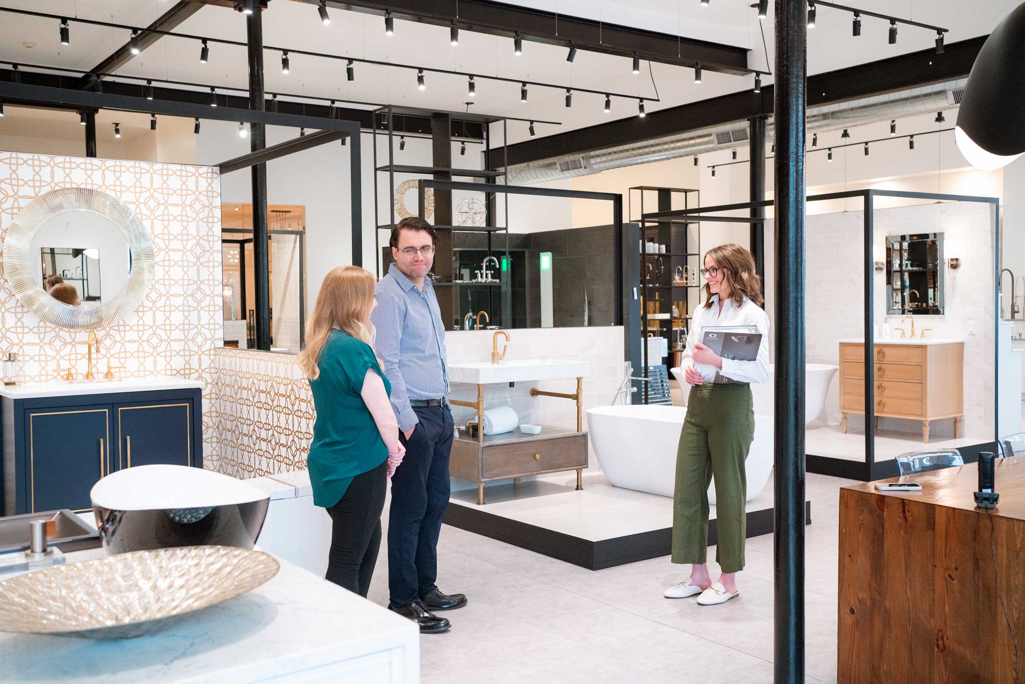 Showroom associate assisting customers in a plumbing showroom